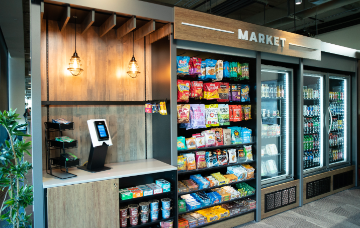 The Market vending kiosk offering pre-packaged snacks, fresh food, and a variety of candy.